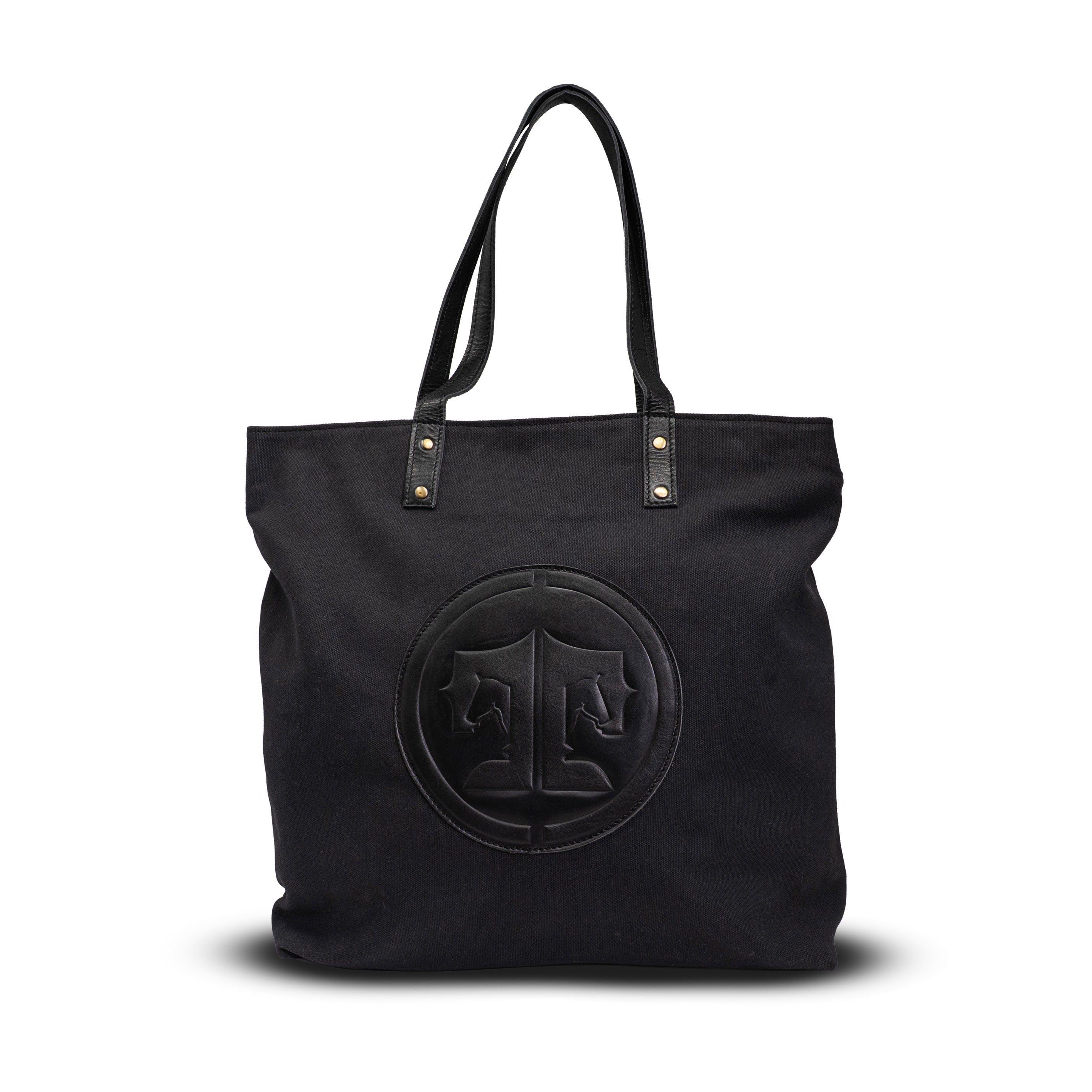 Black tote bag with a circular logo on a white background