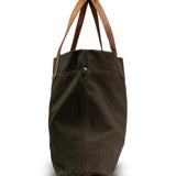Green tote bag with brown handles on a white background