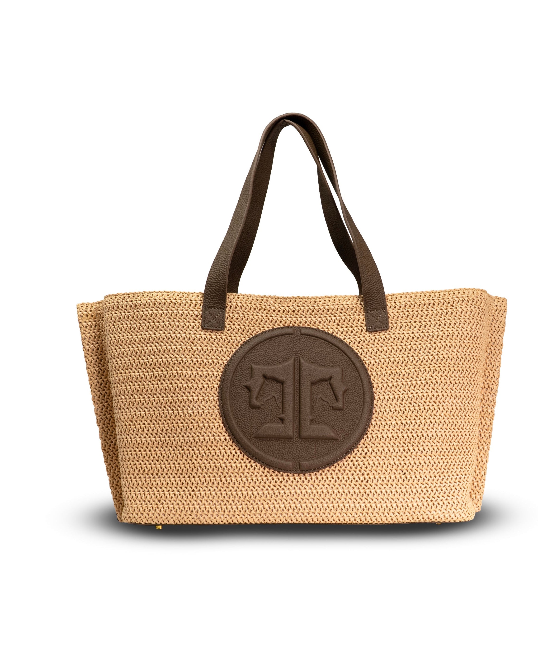 Beige straw tote bag with brown leather handles and logo on a white background