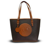 Brown leather handbag with a circular emblem on a white background