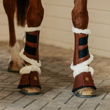 Horse wearing fleece tendon boots & bell boots in cognac by Sixteen Cypress.
